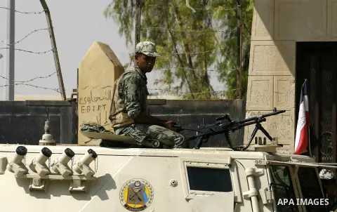 An Egyptian soldier keeps guard as he sits atop a military vehicle at Rafah border crossing between Egypt and southern Gaza Strip August 14, 2012. Egypt opened the crossing temporarily on Tuesday, but just for three days...
