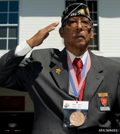 Aug. 14, 2012 - Oceanside, California, U.S. - Lowell Arnold, 86, of Inglewood, Calif. salutes during a commemorative ceremony at Camp Pendleton where he and eight other Montford Point Marines were awarded with a replica...
