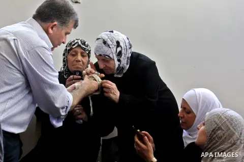 Palestinian Muslim touch a hair of Prophet Mohammed in the 27th Day of the holy month of Ramadan at a mosque in the West Bank city of Nablus, August 15, 2012. 27th Ramadan is the Islamic event of Night of Decree, known a...