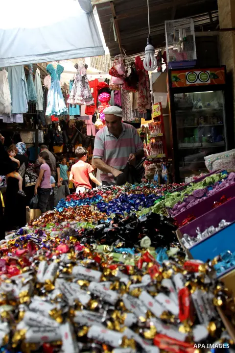 A Palestinian vendor displays his goods in the main market during preparations for the Eid Al-Fitr feast in the West Bank city of Nablus on Aug 16, 2012, as Muslims over the world prepare to celebrate Eid al-Fitr, a thre...