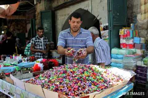 A Palestinian vendor displays his goods in the main market during preparations for the Eid Al-Fitr feast in the West Bank city of Nablus on Aug 16, 2012, as Muslims over the world prepare to celebrate Eid al-Fitr, a thre...