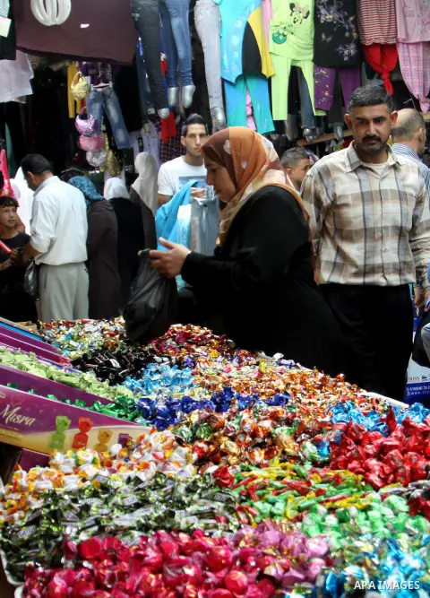 A Palestinian vendor displays his goods in the main market during preparations for the Eid Al-Fitr feast in the West Bank city of Nablus on Aug 16, 2012, as Muslims over the world prepare to celebrate Eid al-Fitr, a thre...