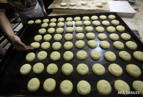 Palestinian workers make traditional date-filled cookies in preparation for the Eid al-Fitr holiday at bakery in the Gaza Strip on August 16, 2012. Muslims around the world are preparing to celebrate the Eid al-Fitr holi...