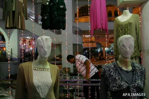 A Palestinian vendor displays his goods at a market in the southern Gaza strip town of Rafah on Aug 16,2012, as Muslims over the world prepare to celebrate Eid al-Fitr, a three day holiday marking the end of the religiou...