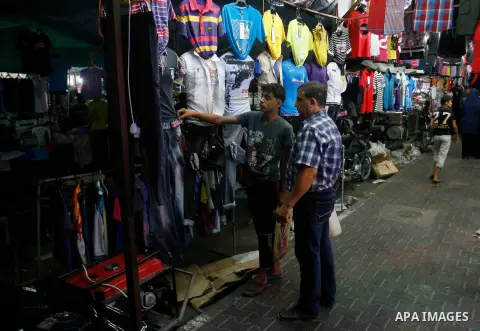 A Palestinian vendor displays his goods at a market in the southern Gaza strip town of Rafah on Aug 16,2012, as Muslims over the world prepare to celebrate Eid al-Fitr, a three day holiday marking the end of the religiou...
