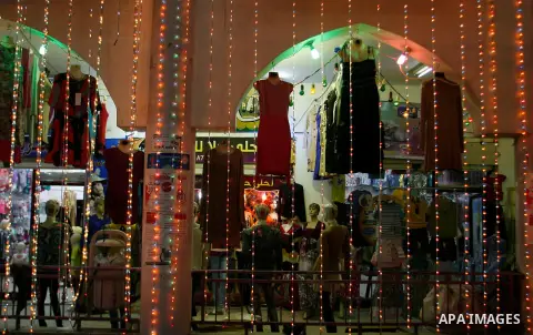 A Palestinian vendor displays his goods at a market in the southern Gaza strip town of Rafah on Aug 16,2012, as Muslims over the world prepare to celebrate Eid al-Fitr, a three day holiday marking the end of the religiou...