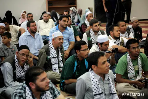 Members of " Miles of Smiles 15 " aid convoy meets with members of Palestinian Parliament at a mosque before breaking their fast during the holy month of Ramadan in Gaza city, on Aug 16, 2012. Photo by Ashraf Amra