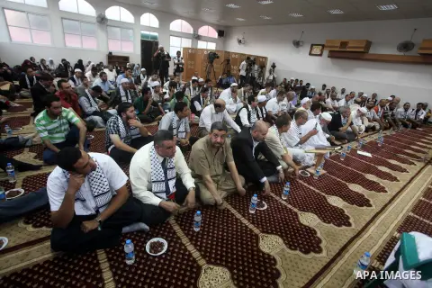 Members of " Miles of Smiles 15 " aid convoy meets with members of Palestinian Parliament at a mosque before breaking their fast during the holy month of Ramadan in Gaza city, on Aug 16, 2012. Photo by Ashraf Amra