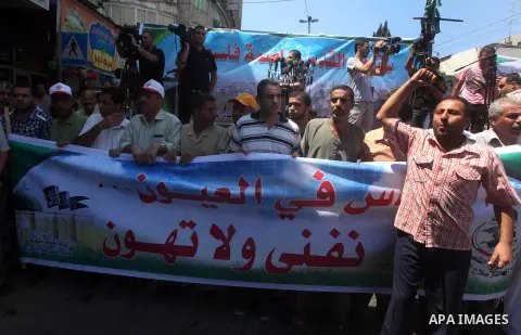 Palestinian demonstrators chant slogans during an annual rally marking Al-Quds Day (Jerusalem Day), on the last Friday of the holy month of Ramadan, in Gaza city, Friday, Aug. 17, 2012. Photo by Ashraf Amra