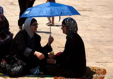 Palestinian Muslim women pray outside the Dome of the Rock at al-Aqsa mosque compound, Islam's third holiest site, on August 17, 2012, in the old city of Jerusalem, on the last Friday of the Muslim holy fasting month of...