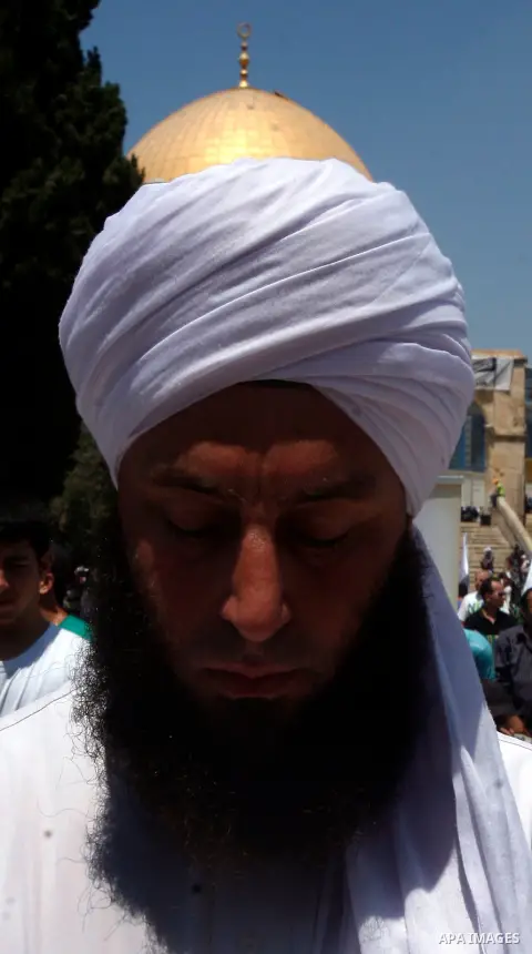 A Palestinian Muslim man prays outside the Dome of the Rock at al-Aqsa mosque compound, Islam's third holiest site, on August 17, 2012, in the old city of Jerusalem, on the last Friday of the Muslim holy fasting month of...