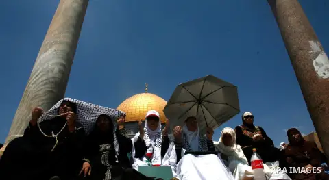 Palestinian Muslim women pray outside the Dome of the Rock at al-Aqsa mosque compound, Islam's third holiest site, on August 17, 2012, in the old city of Jerusalem, on the last Friday of the Muslim holy fasting month of...