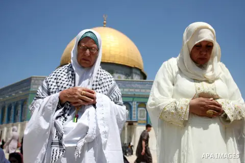 Palestinian women worshippers pray outside the Dome of the Rock at al-Aqsa mosque compound, Islam's third holiest site, on August 17, 2012, in the old city of Jerusalem, on the last Friday of the Muslim holy fasting mont...