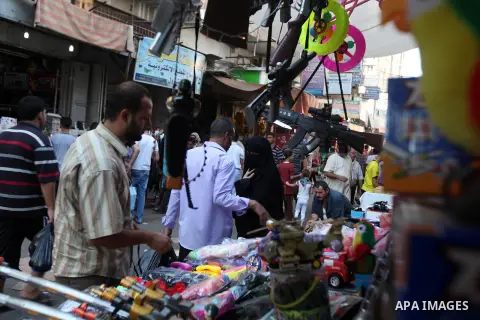 Palestinians buy toys at the main market during preparations for the Eid Al-Fitr feast Gaza city on Aug 18, 2012, as Muslims over the world prepare to celebrate Eid al-Fitr, a three day holiday marking the end of the rel...