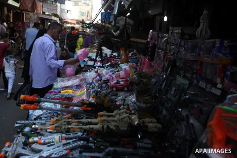 Palestinians buy toys at the main market during preparations for the Eid Al-Fitr feast Gaza city on Aug 18, 2012, as Muslims over the world prepare to celebrate Eid al-Fitr, a three day holiday marking the end of the rel...