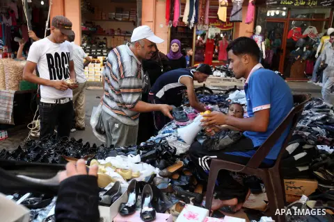Palestinian shoemaker works at the main market during preparations for the Eid Al-Fitr feast Gaza city on Aug 18, 2012, as Muslims over the world prepare to celebrate Eid al-Fitr, a three day holiday marking the end of t...