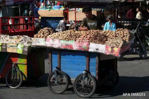 A Palestinian vendor displays the cakes at the main market during preparations for the Eid Al-Fitr feast Gaza city on Aug 18, 2012, as Muslims over the world prepare to celebrate Eid al-Fitr, a three day holiday marking...