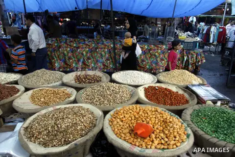 A Palestinian vendor sells nuts in the market during preparations for the Eid Al-Fitr feast in Rafah in the southern of Gaza strip on Aug 16, 2012, as Muslims over the world prepare to celebrate Eid al-Fitr, a three day...