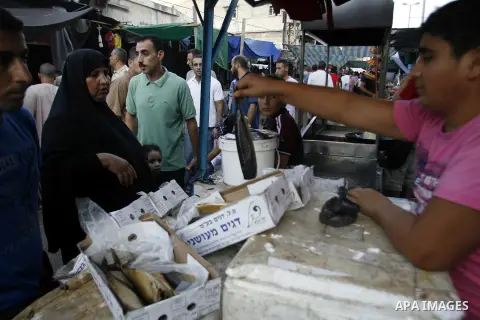 A Palestinian vendor sells salted fish in the market during preparations for the Eid Al-Fitr feast in Rafah in the southern of Gaza strip on Aug 16, 2012, as Muslims over the world prepare to celebrate Eid al-Fitr, a thr...