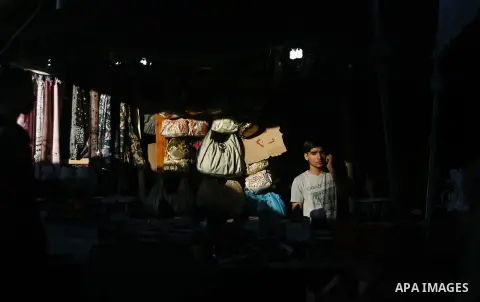 Palestinians shop at the market during preparations for the Eid Al-Fitr feast in Rafah in the southern of Gaza strip on Aug 16, 2012, as Muslims over the world prepare to celebrate Eid al-Fitr, a three day holiday markin...