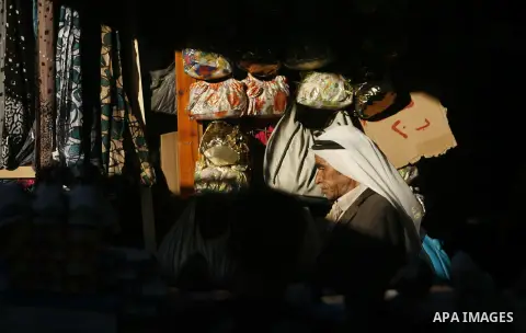 Palestinians shop at the market during preparations for the Eid Al-Fitr feast in Rafah in the southern of Gaza strip on Aug 16, 2012, as Muslims over the world prepare to celebrate Eid al-Fitr, a three day holiday markin...