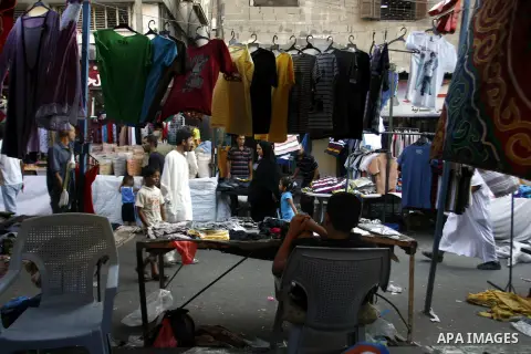 Palestinians shop at the market during preparations for the Eid Al-Fitr feast in Rafah in the southern of Gaza strip on Aug 16, 2012, as Muslims over the world prepare to celebrate Eid al-Fitr, a three day holiday markin...