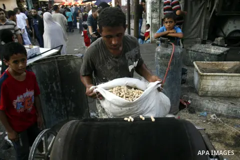 A Palestinian vendor sells nuts in the market during preparations for the Eid Al-Fitr feast in Rafah in the southern of Gaza strip on Aug 16, 2012, as Muslims over the world prepare to celebrate Eid al-Fitr, a three day...
