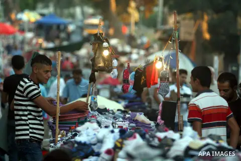 A Palestinian vendor displays his goods in the market during preparations for the Eid Al-Fitr feast in the West Bank city of Ramallah, on Aug 16, 2012, as Muslims over the world prepare to celebrate Eid al-Fitr, a three...