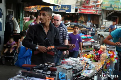 A Palestinian vendor sells toys in the market during preparations for the Eid Al-Fitr feast in the West Bank city of Ramallah, on Aug 16, 2012, as Muslims over the world prepare to celebrate Eid al-Fitr, a three day holi...