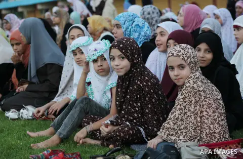 Palestinians attend Eid al-Fitr prayers at the Palestine Stadium in Gaza City August 19, 2012. Eid al-Fitr marks the end of the Muslim holy month of Ramadan. Photo by Ashraf Amra