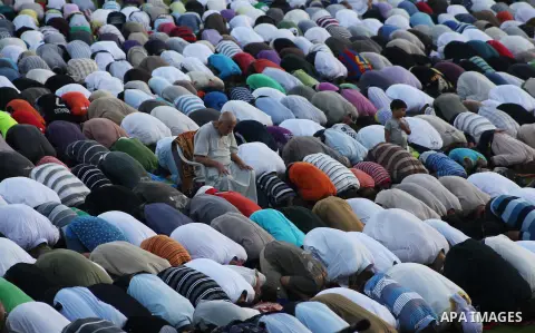 Palestinians attend Eid al-Fitr prayers at the Palestine Stadium in Gaza City August 19, 2012. Eid al-Fitr marks the end of the Muslim holy month of Ramadan. Photo by Ashraf Amra