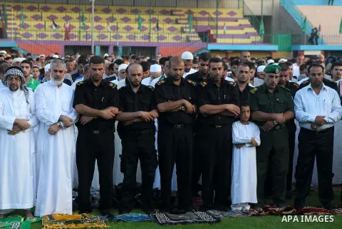 Palestinians attend Eid al-Fitr prayers at the Palestine Stadium in Gaza City August 19, 2012. Eid al-Fitr marks the end of the Muslim holy month of Ramadan. Photo by Ashraf Amra
