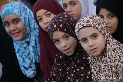 Palestinians attend Eid al-Fitr prayers at the Palestine Stadium in Gaza City August 19, 2012. Eid al-Fitr marks the end of the Muslim holy month of Ramadan. Photo by Ashraf Amra