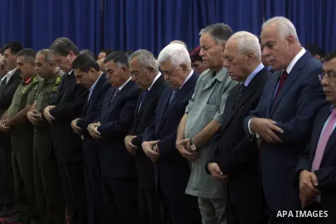 Palestinian President Mahmoud Abbas and his Prime Minister Salam Fayyad attend the early morning Eid Al-Fitr prayer at the Palestinian Authority headquarters in the West Bank city of Ramallah on Aug. 19, 2012 . Muslims o...