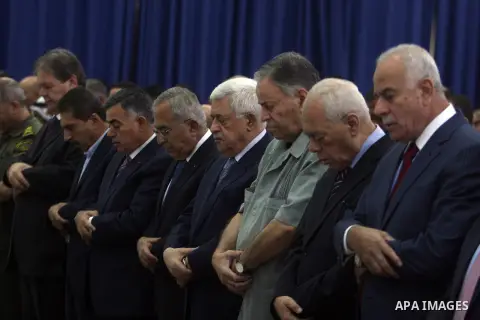 Palestinian President Mahmoud Abbas and his Prime Minister Salam Fayyad attend the early morning Eid Al-Fitr prayer at the Palestinian Authority headquarters in the West Bank city of Ramallah on Aug. 19, 2012 . Muslims o...