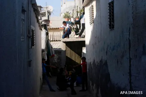 Palestinian children play with a gun toy on the Second day of Eid al-Fitr in Rafah in the southern of Gaza strip, Aug. 20, 2012. which marks the end of the Muslim fasting month of Ramadan. Eid, one of the most important...