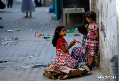 Palestinian girls play during the Second day of Eid al-Fitr in Rafah in the southern of Gaza strip, Aug. 20, 2012. which marks the end of the Muslim fasting month of Ramadan. Eid, one of the most important holidays in th...