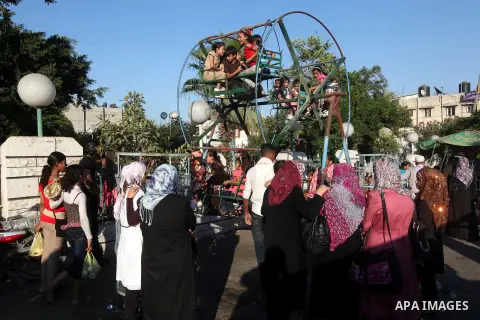 Palestinian children play at a park during the Second day of Eid al-Fitr in Gaza city, Aug. 20, 2012. which marks the end of the Muslim fasting month of Ramadan. Eid, one of the most important holidays in the Muslim worl...