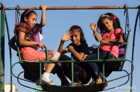 Palestinian children play at a park during the Second day of Eid al-Fitr in Gaza city, Aug. 20, 2012. which marks the end of the Muslim fasting month of Ramadan. Eid, one of the most important holidays in the Muslim worl...