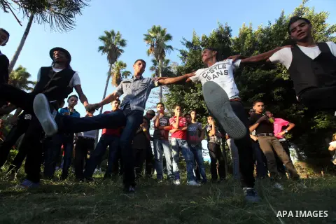 Palestinian youths dance at a park during the Second day of Eid al-Fitr in Gaza city, Aug. 20, 2012. which marks the end of the Muslim fasting month of Ramadan. Eid, one of the most important holidays in the Muslim world...