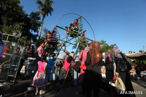 Palestinian children play at a park during the Second day of Eid al-Fitr in Gaza city, Aug. 20, 2012. which marks the end of the Muslim fasting month of Ramadan. Eid, one of the most important holidays in the Muslim worl...