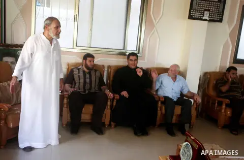 Palestinian Hamas leader Mahmoud al-Zahar recieves congratulations of Eid al-Fitr at his house in Gaza city, Aug. 20, 2012. which marks the end of the Muslim fasting month of Ramadan. Eid, one of the most important holid...