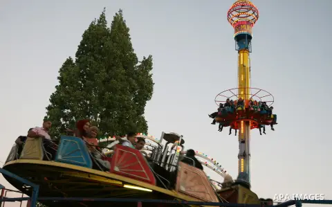 Palestinians enjoy the second day of Eid al-Fitr in an amusement park, in the West Bank city of Ramallah, Monday, Aug. 20, 2012. Eid, one of the most important holidays in the Muslim world, is marked with prayers, family...