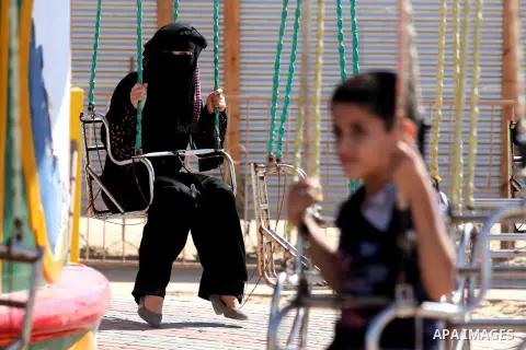 Palestinians enjoy a ride in an amusement park on the third day of Eid al-Fitr, marking the end of Islam's fasting holy month of Ramadan, in Gaza City on August 21, 2012. Photo by Majdi Fathi