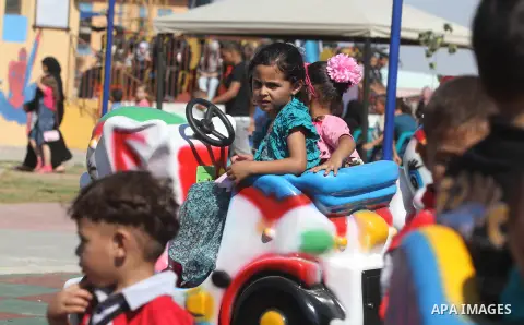 Palestinians enjoy a ride in an amusement park on the third day of Eid al-Fitr, marking the end of Islam's fasting holy month of Ramadan, in Gaza City on August 21, 2012. Photo by Majdi Fathi