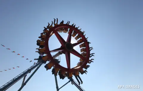 Palestinians enjoy a ride in an amusement park on the third day of Eid al-Fitr, marking the end of Islam's fasting holy month of Ramadan, in Gaza City on August 21, 2012. Photo by Majdi Fathi