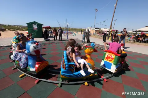 Palestinians enjoy a ride in an amusement park on the third day of Eid al-Fitr, marking the end of Islam's fasting holy month of Ramadan, in Gaza City on August 21, 2012. Photo by Majdi Fathi