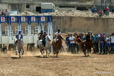 Palestinian jockeys ride their horses during a race in the West Bank city of Nablus on Aug 21, 2012. Hundreds of Palestinians from all over the West Bank gathered to follow the horse race on Tuesday in the northern West...
