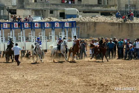 Palestinian jockeys ride their horses during a race in the West Bank city of Nablus on Aug 21, 2012. Hundreds of Palestinians from all over the West Bank gathered to follow the horse race on Tuesday in the northern West...
