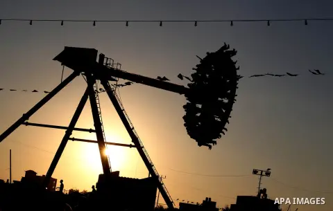 Palestinians enjoy a ride in an amusement park on the third day of Eid al-Fitr, marking the end of Islam's fasting holy month of Ramadan, in Gaza City on August 21, 2012. Photo by Ashraf Amra